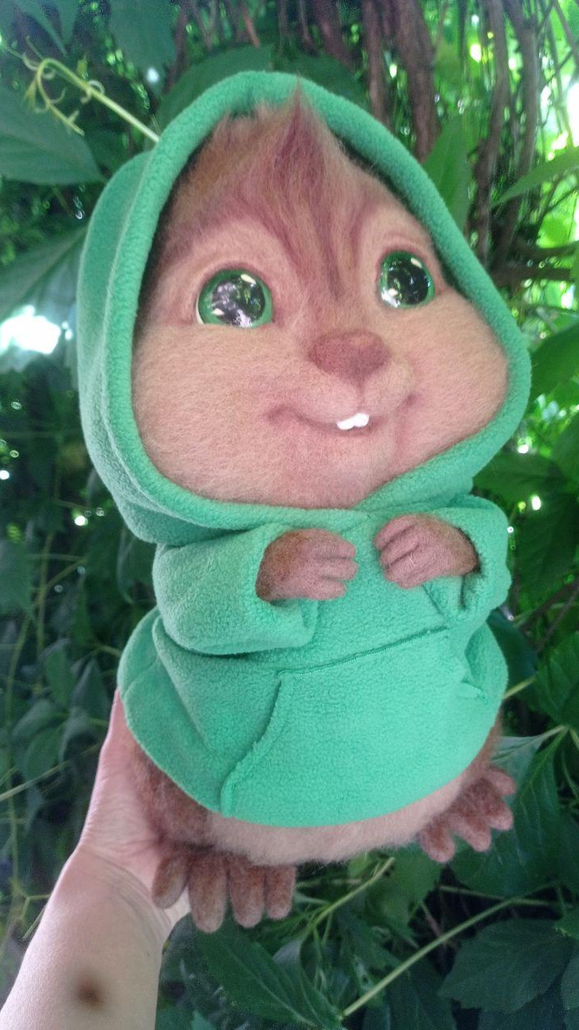 Theodore plush with his green hood up among leaves, needle felted wool chipmunk made to order