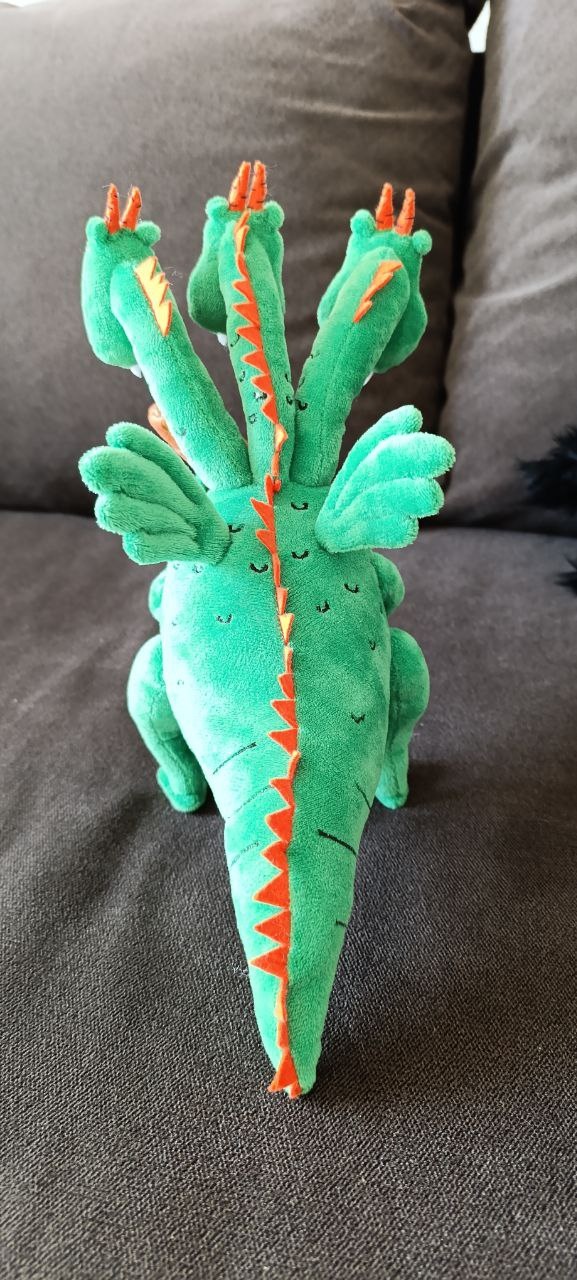 Three-headed dragon plush, wings and spikes Three-headed dragon plush with small green wings and orange spikes down the back and tail, handmade to order