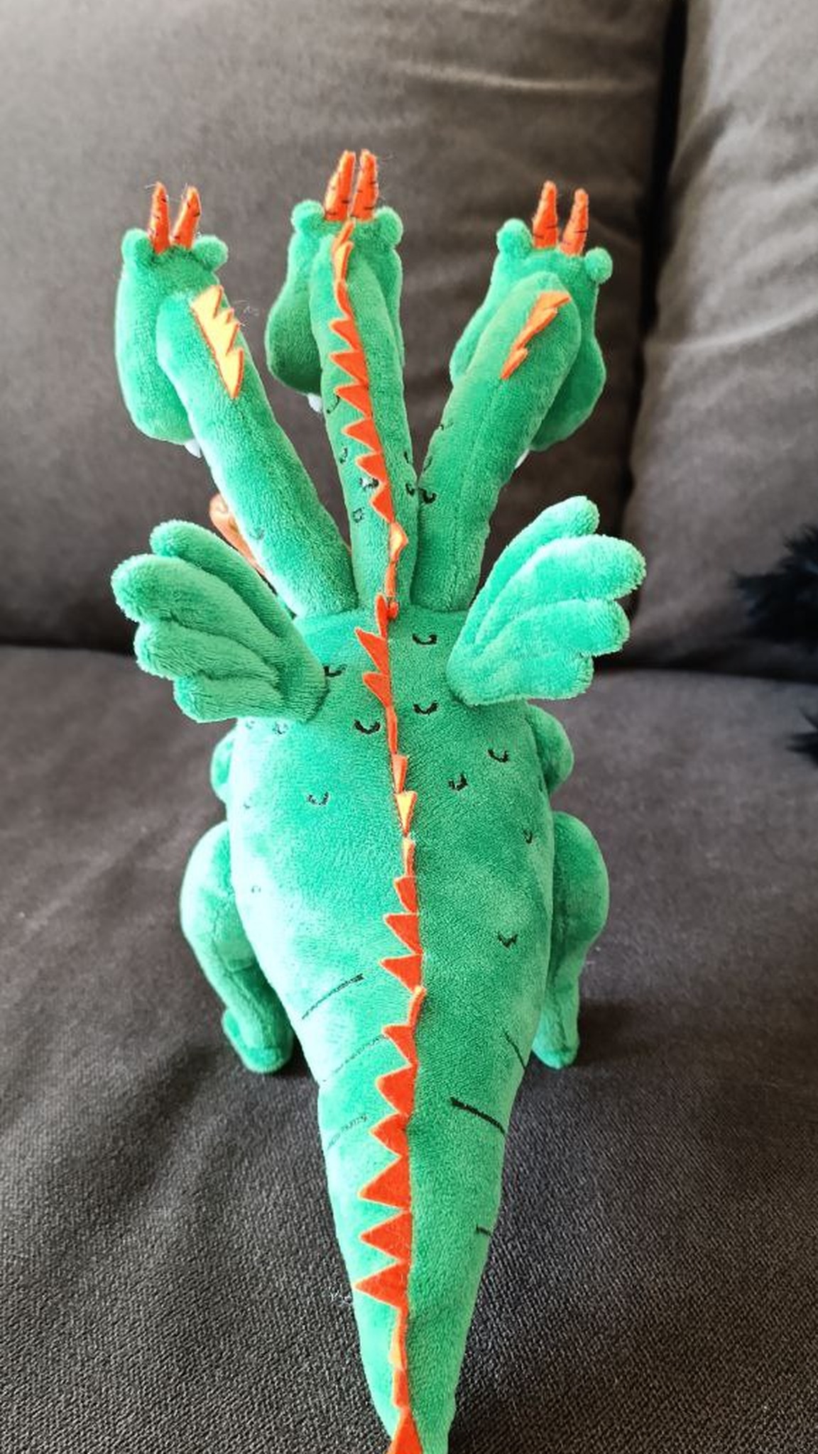 Three-headed dragon plush with pale green wings and orange back spikes to the tail tip, sewn to order