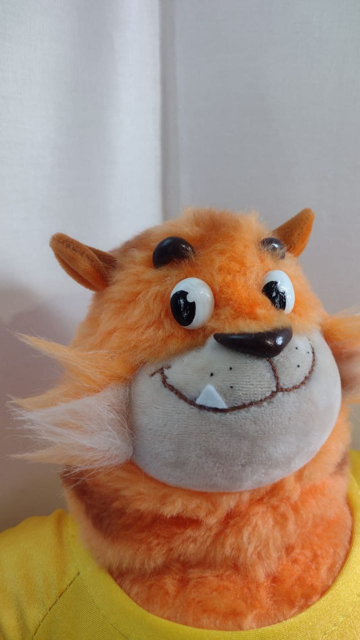 Tiger cat mascot plush face: round eyes, one white tooth and a wide grin on a grey muzzle, made to order