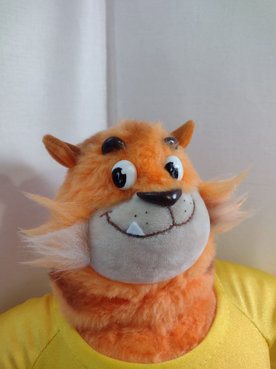 Tiger cat mascot plush face Tiger cat mascot plush face: round eyes, one white tooth and a wide grin on a grey muzzle, made to order