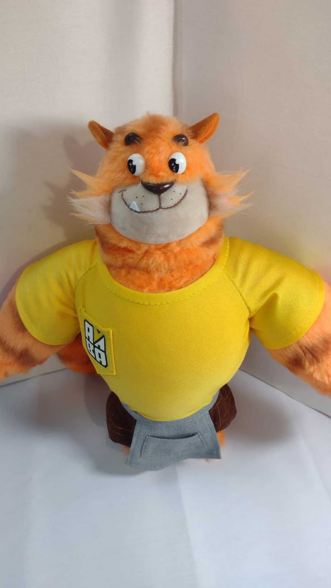 Tiger mascot plush: striped orange cat in a yellow T-shirt with an embroidered logo, handmade to order