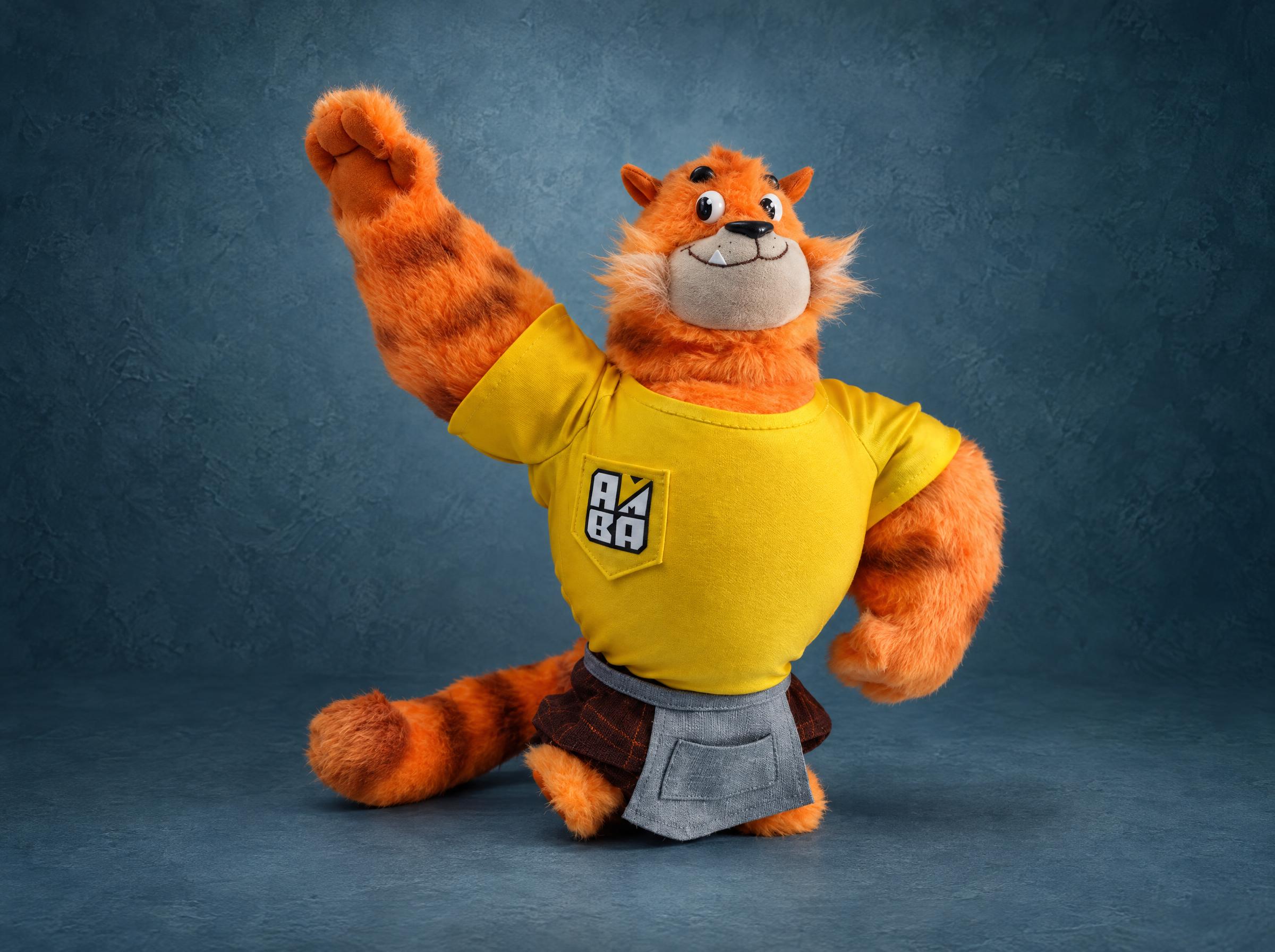 Tiger mascot plush waving a striped paw, yellow T-shirt with an embroidered logo and grey apron, made to order