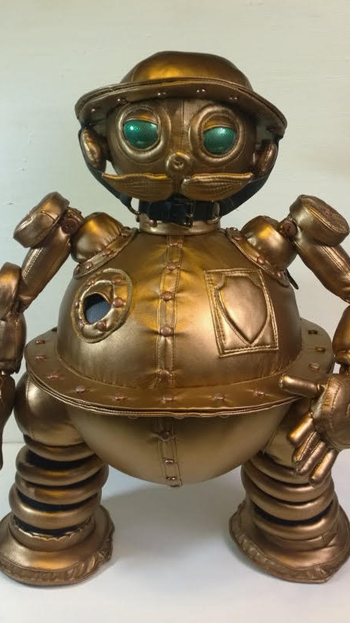 Tik-Tok plush face with glossy green eyes, a padded moustache and a buckled chin strap, handmade Oz robot
