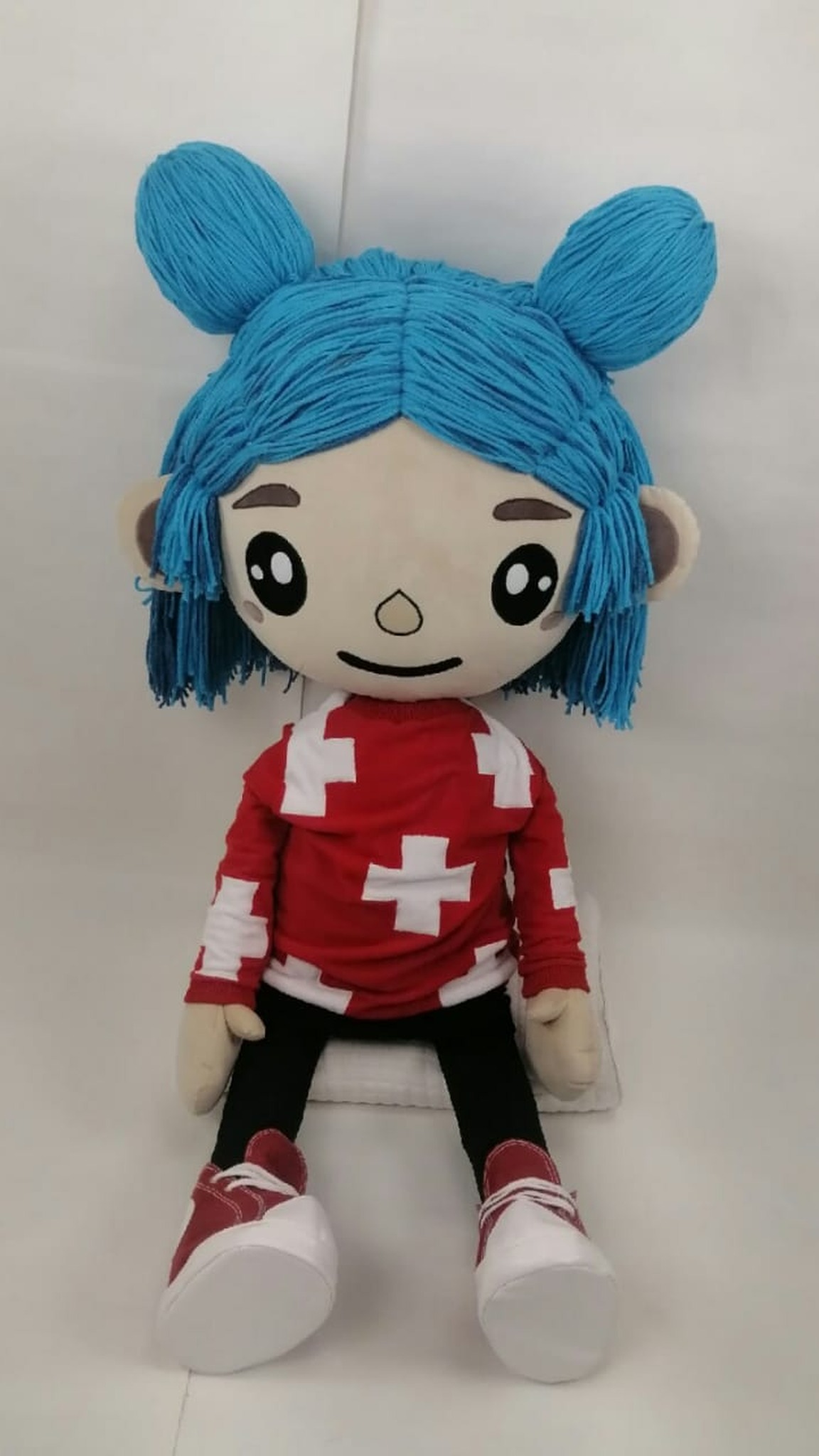 Toca Boca doll with turquoise hair buns and a red top with white crosses, sewn by hand to order