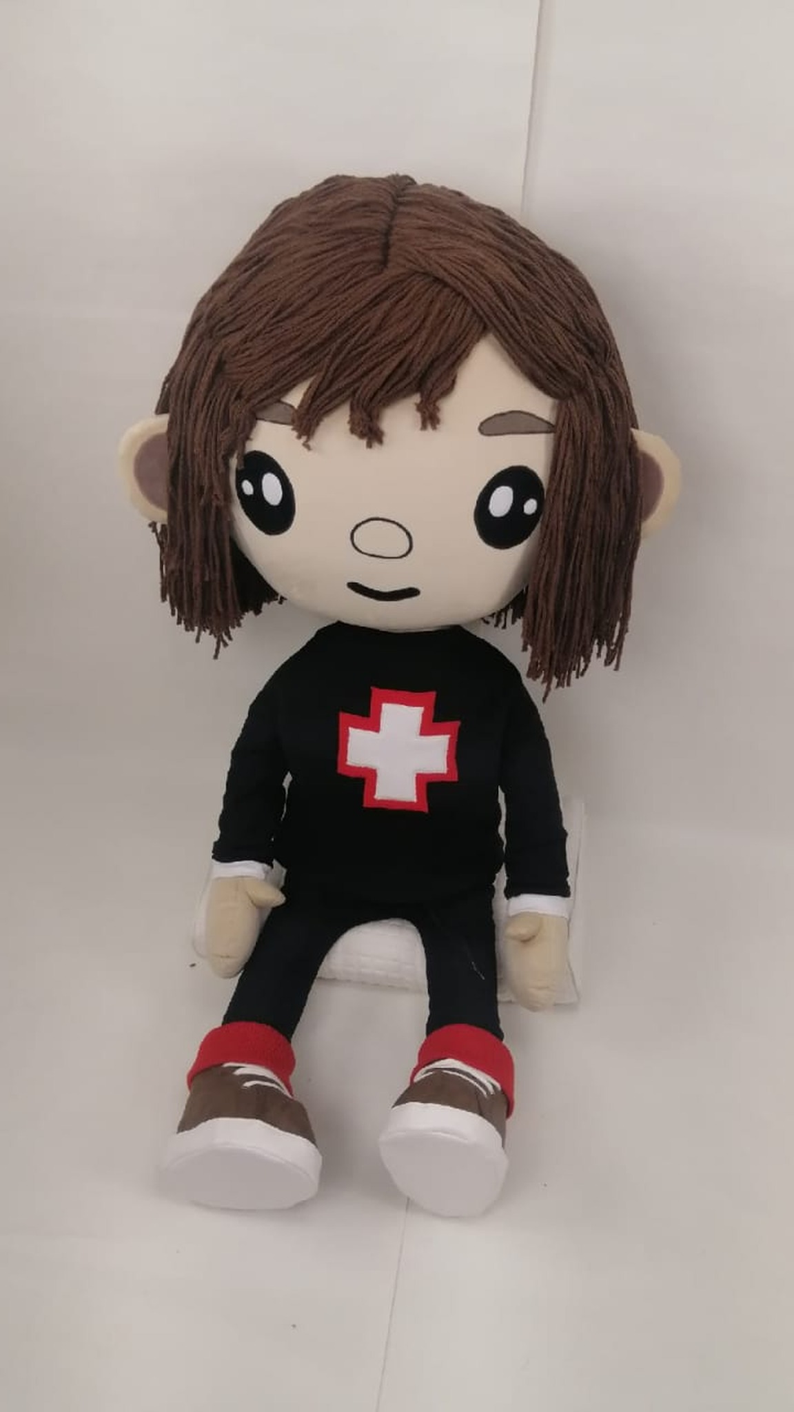 Toca Boca doll with long brown yarn hair and a black top with one white cross, handmade to order