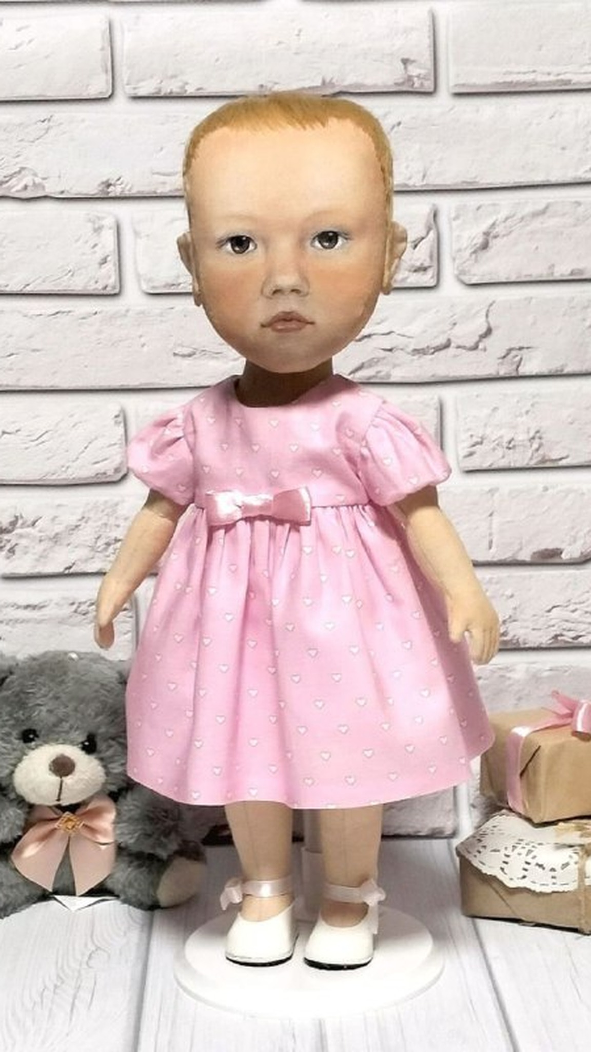 Toddler portrait doll with short strawberry-blonde hair in a pink heart dress, custom baby doll made to order