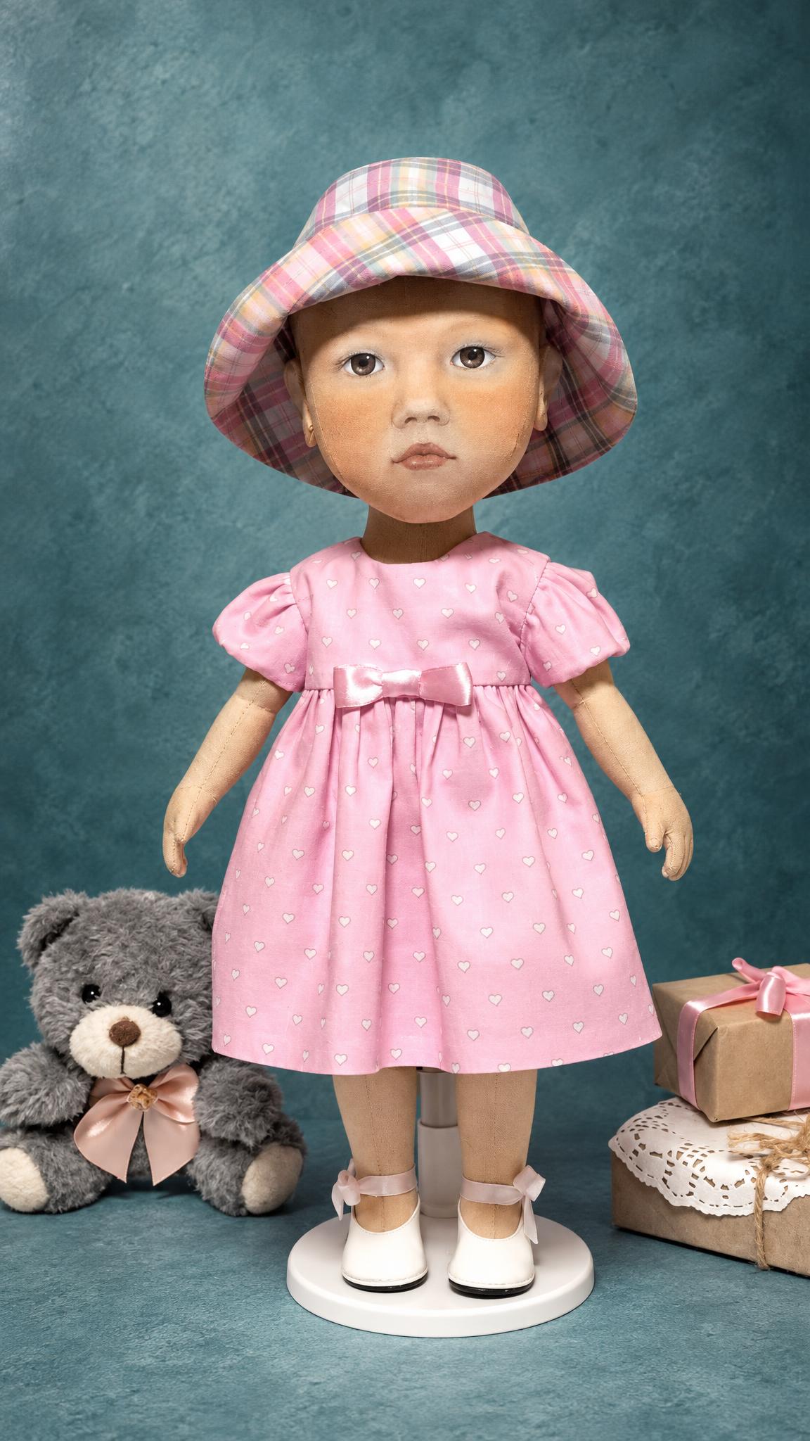 Toddler portrait doll with a hand-painted face, plaid bucket hat and pink dress, custom baby doll sewn to order