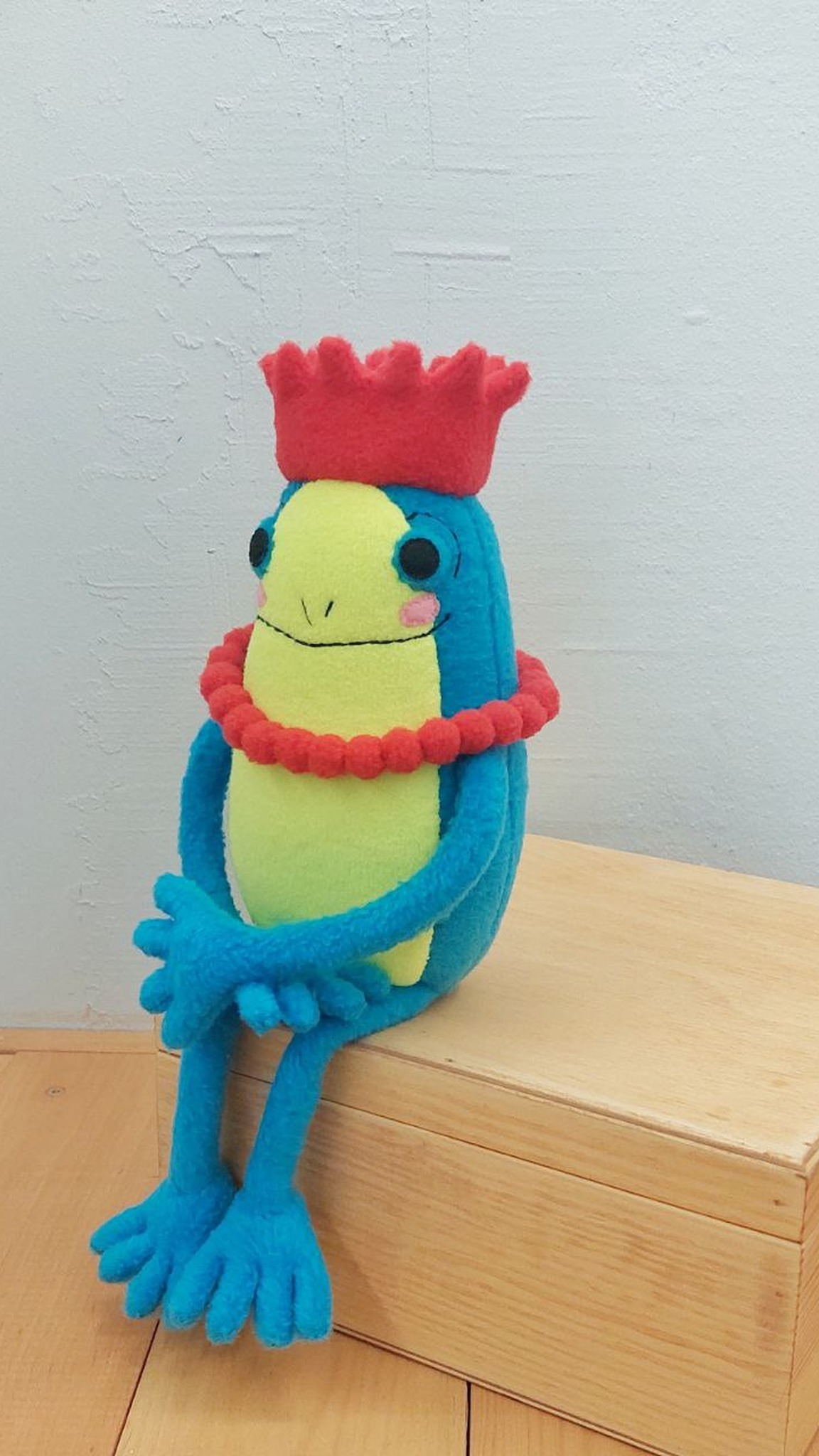 Turquoise frog princess plush with a lime belly and soft red crown, second version of the sticker toy
