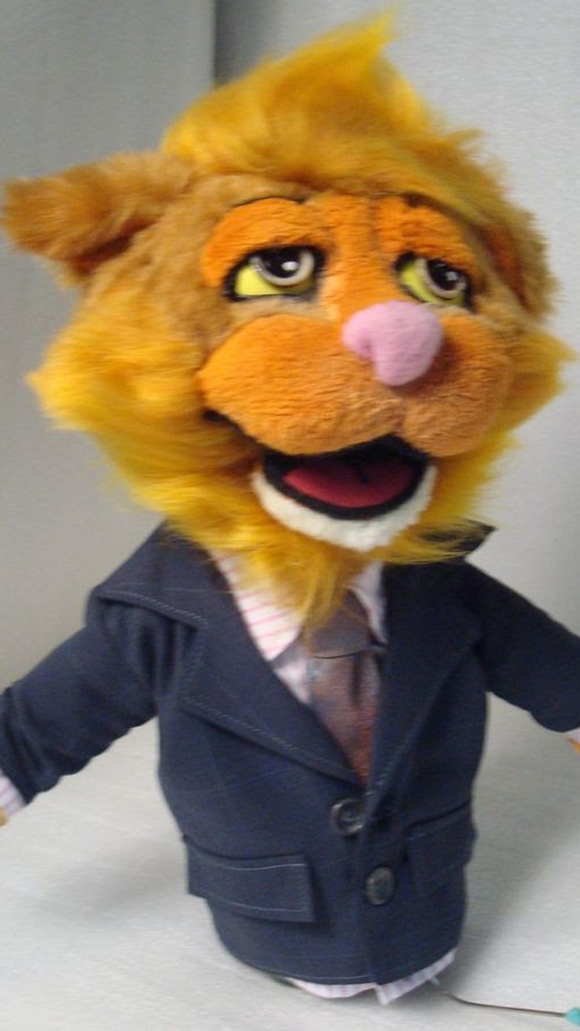 Ginger cat TV puppet with a golden faux fur mane, navy suit and tie, custom hand puppet made to order