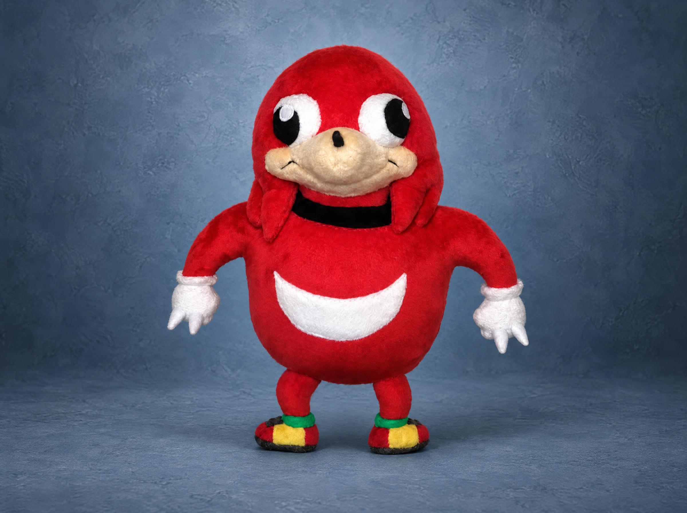 Ugandan Knuckles plush with a round red body, white chest crescent and faux fur mitts, handmade to order
