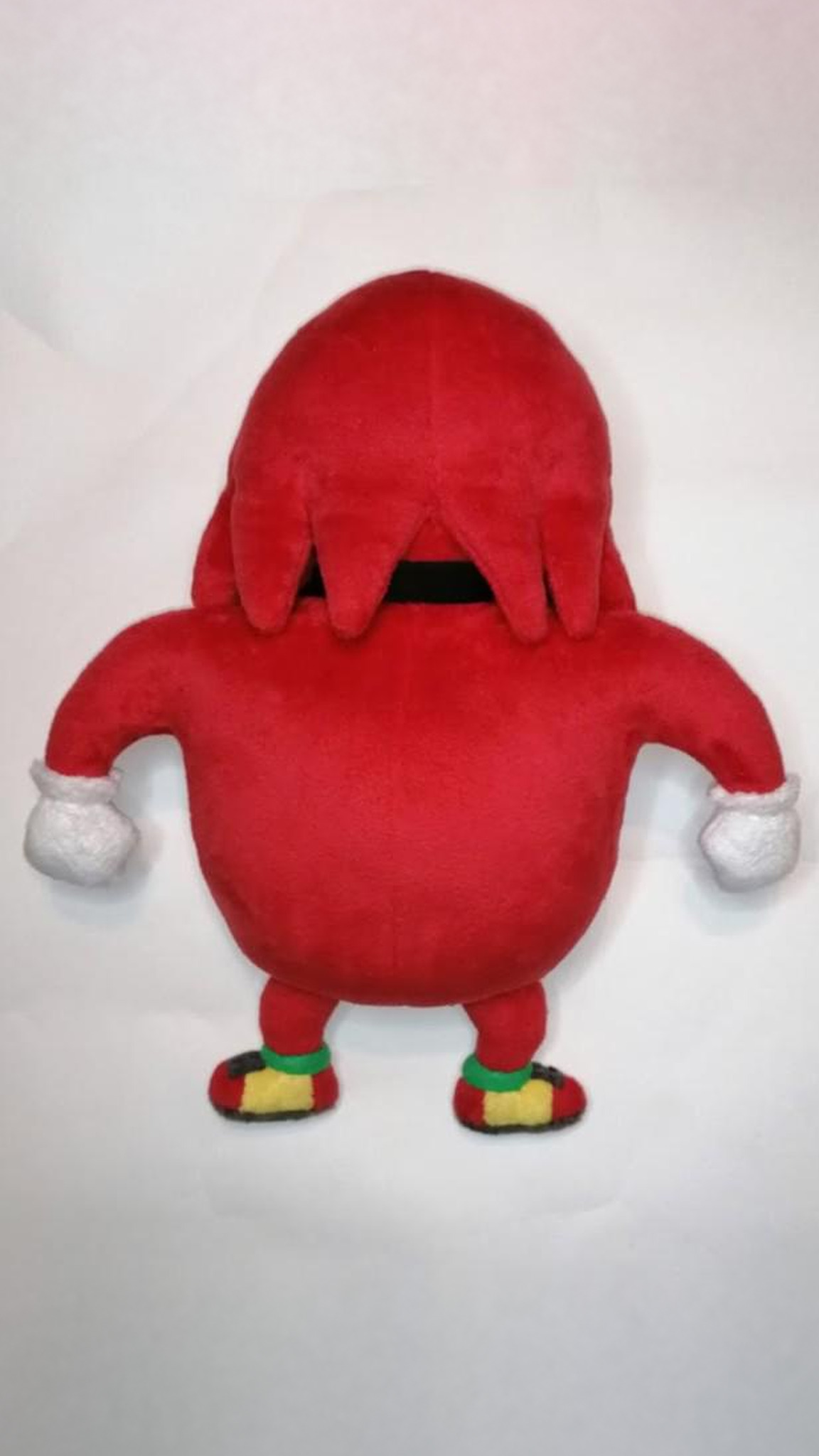 Back of the Ugandan Knuckles plush with red spines over the neck band, custom meme toy sewn by hand