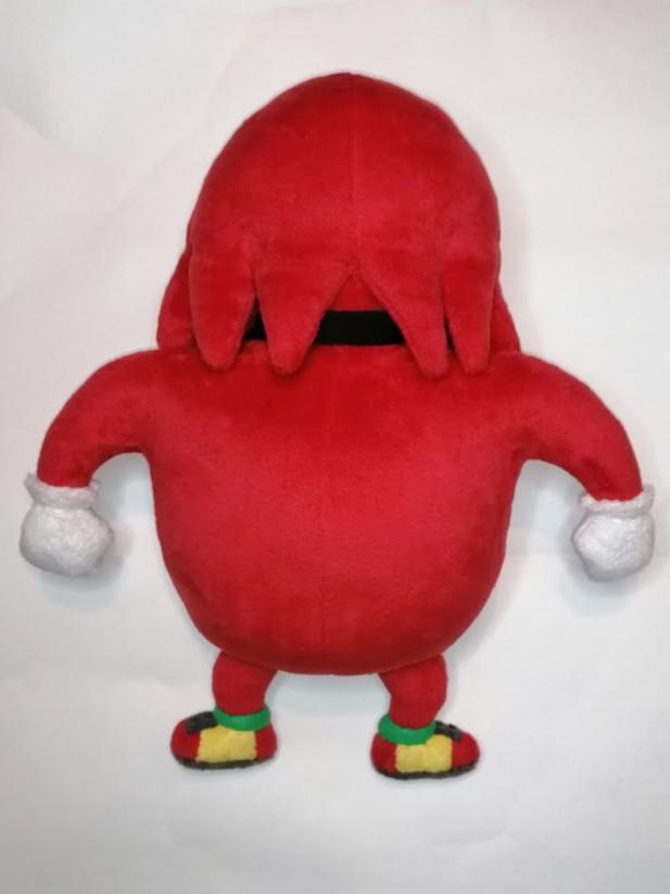 Ugandan Knuckles plush, red spines Back of the Ugandan Knuckles plush with red spines over the neck band, custom meme toy sewn by hand