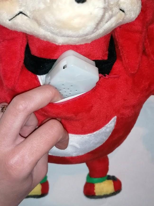 Ugandan Knuckles plush voice module Voice module coming out of the zipped chest pocket of a Ugandan Knuckles talking plush made to order