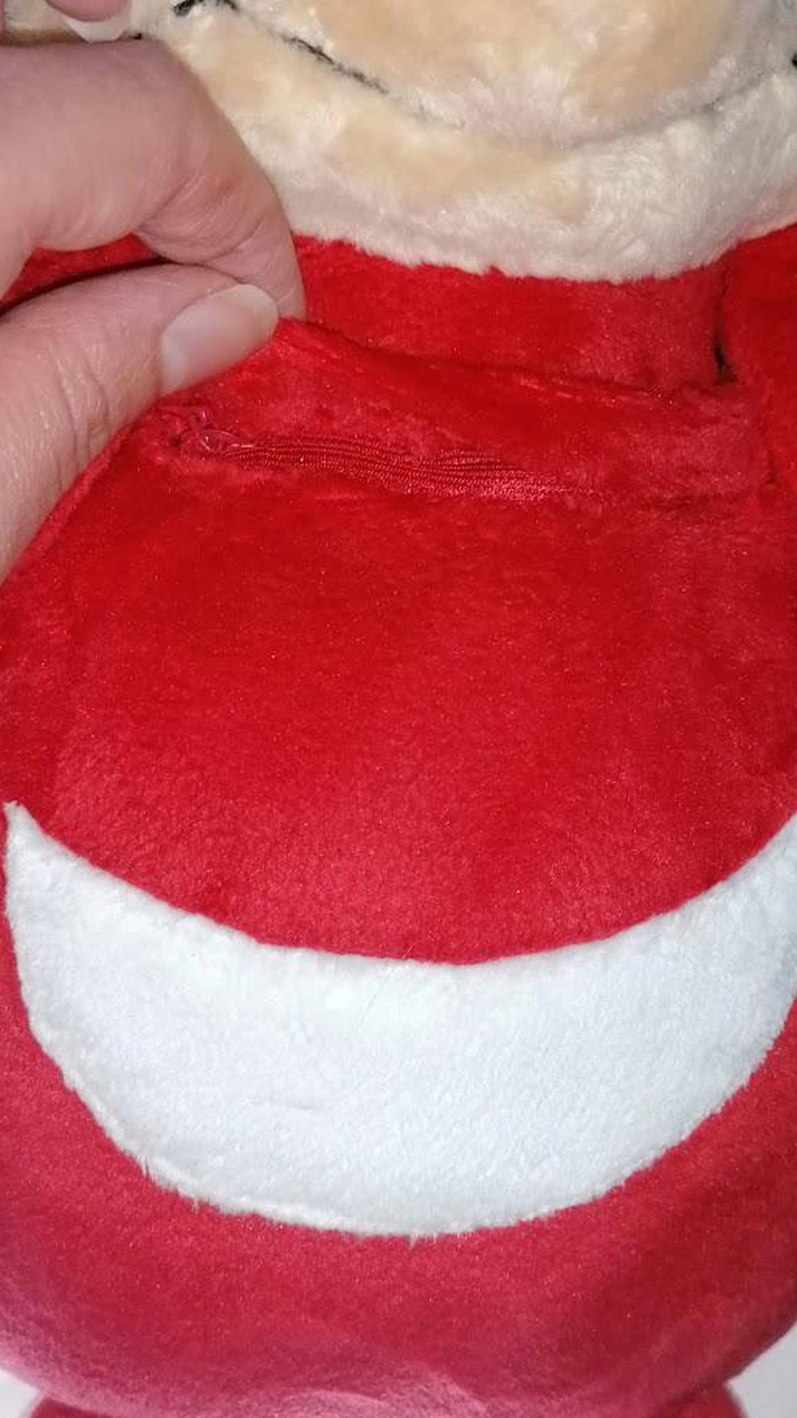 Opening the voice pocket of a handmade Ugandan Knuckles talking plush, red meme toy made to order