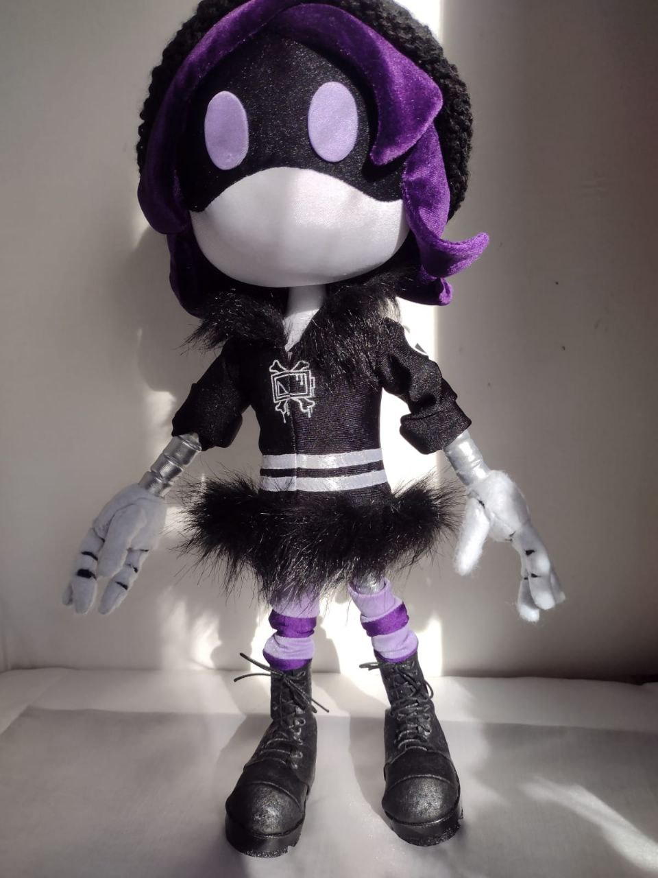 Uzi plush doll, Murder Drones, handmade to order Uzi plush doll from Murder Drones in sunlight: black jacket, fur-trimmed skirt, striped socks, made to order