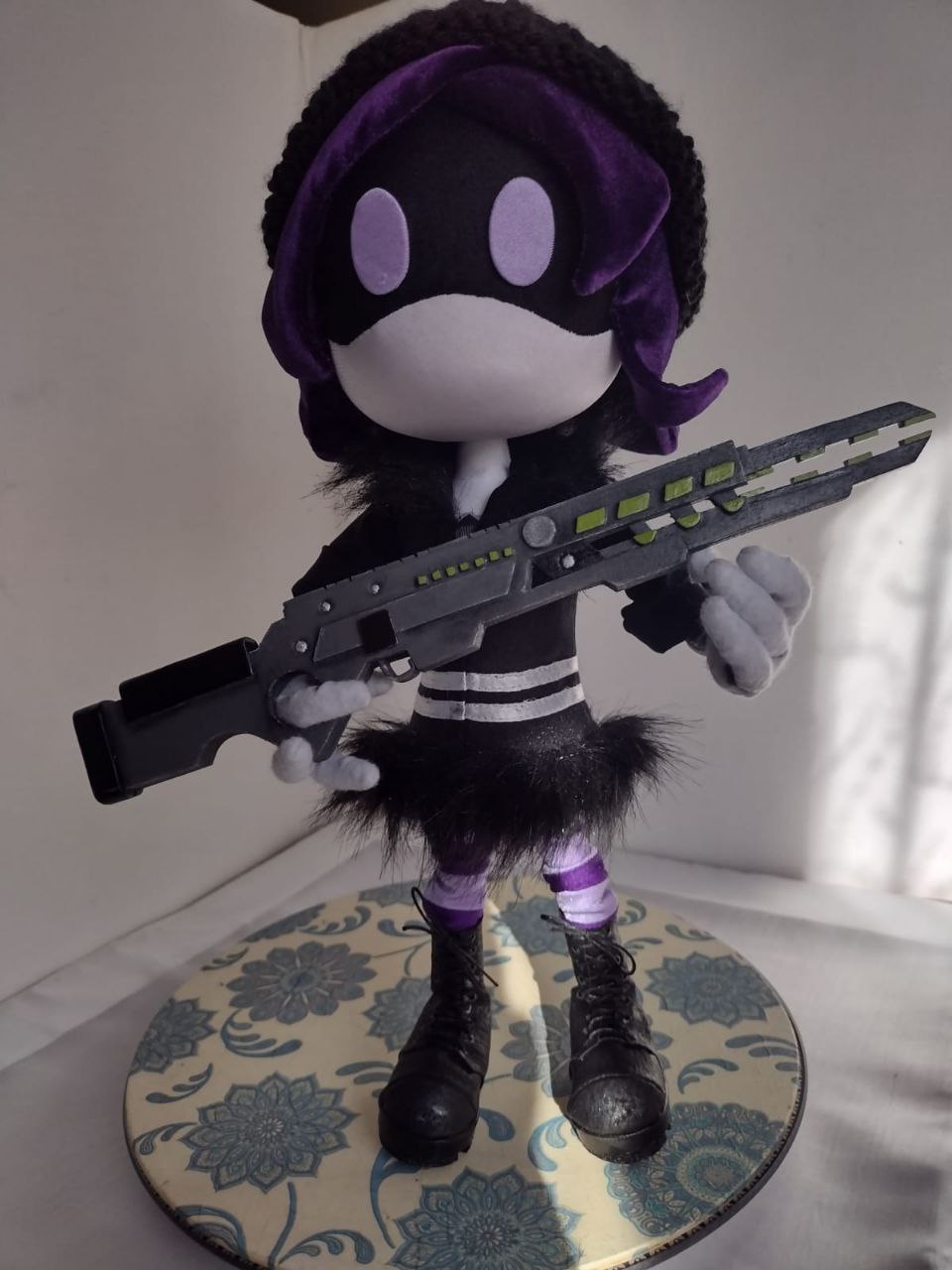 Handmade Uzi Murder Drones plush on a round stand Handmade Uzi Murder Drones plush on a round floral stand with her railgun and lilac visor eyes, sewn to order