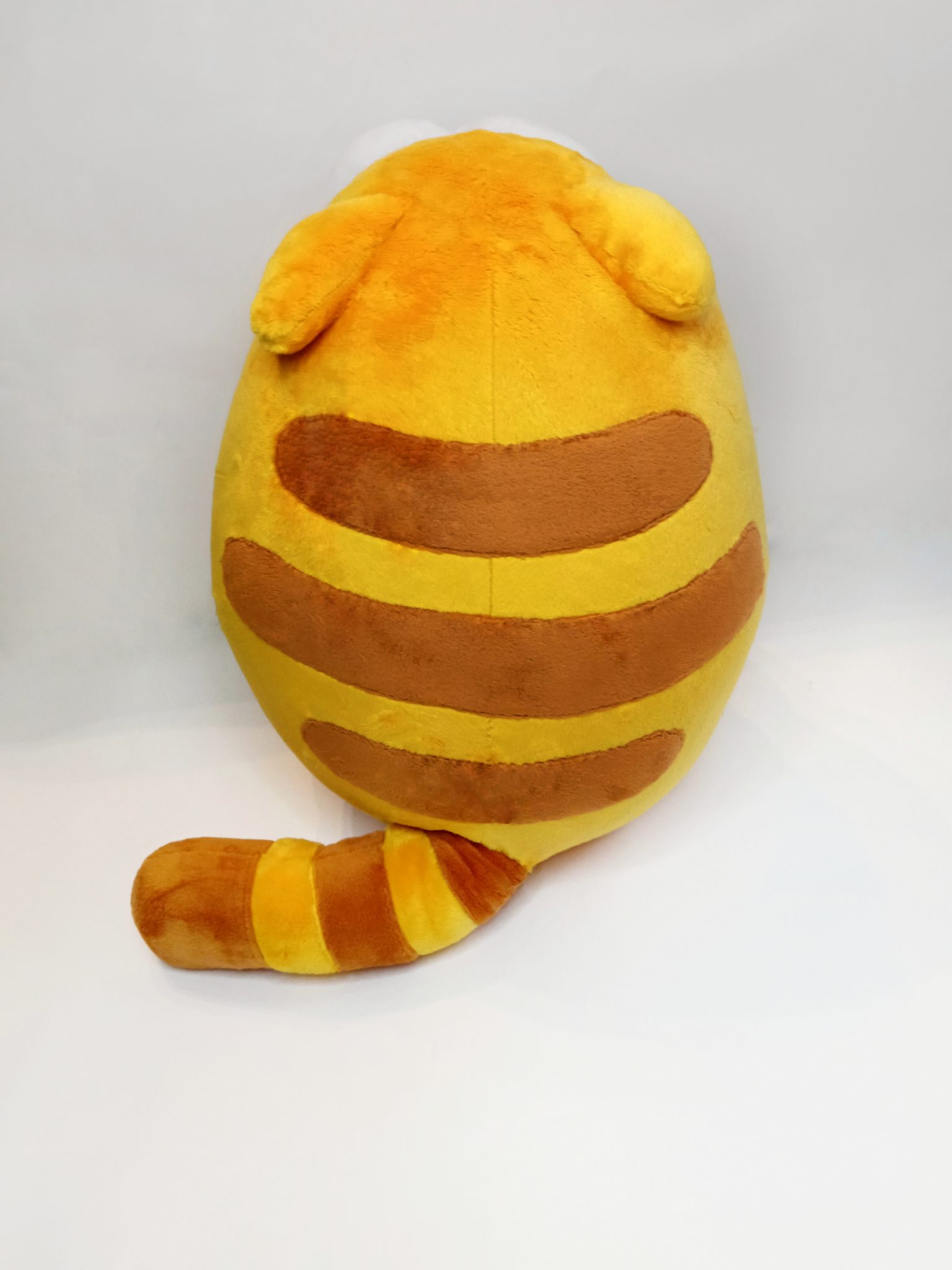 Viber cat plush with brown back stripes Viber cat plush with brown stripes across its yellow back and a striped tail, sewn by hand to order