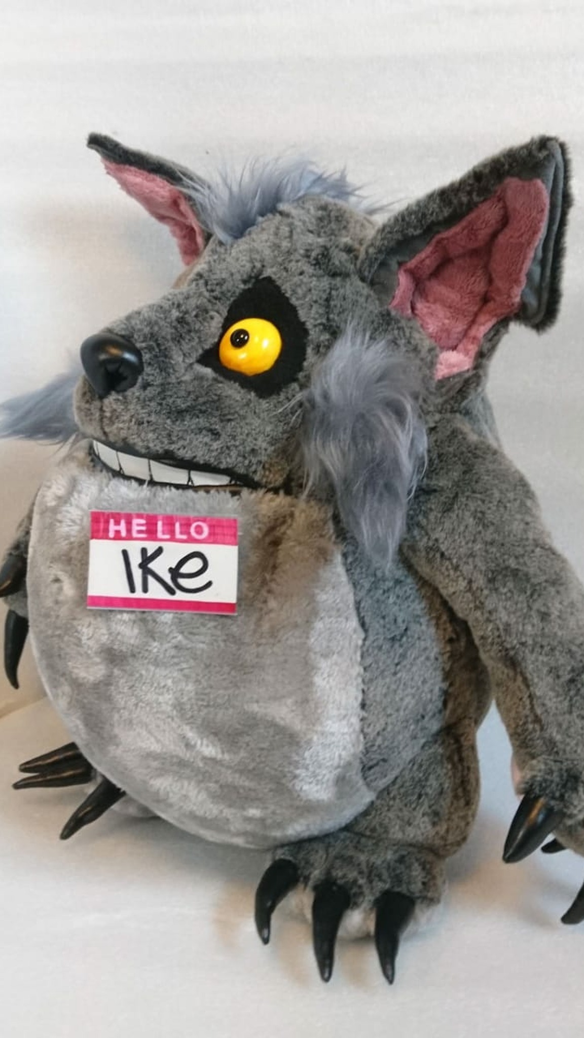 Werewolf-style monster plush Ike with long black claws, pink-lined ears and a HELLO badge, handmade to order