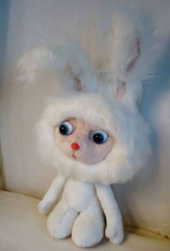 White cartoon bunny plush with blue eyes White cartoon bunny plush with round blue eyes and a red nose, custom sewn from a cartoon character