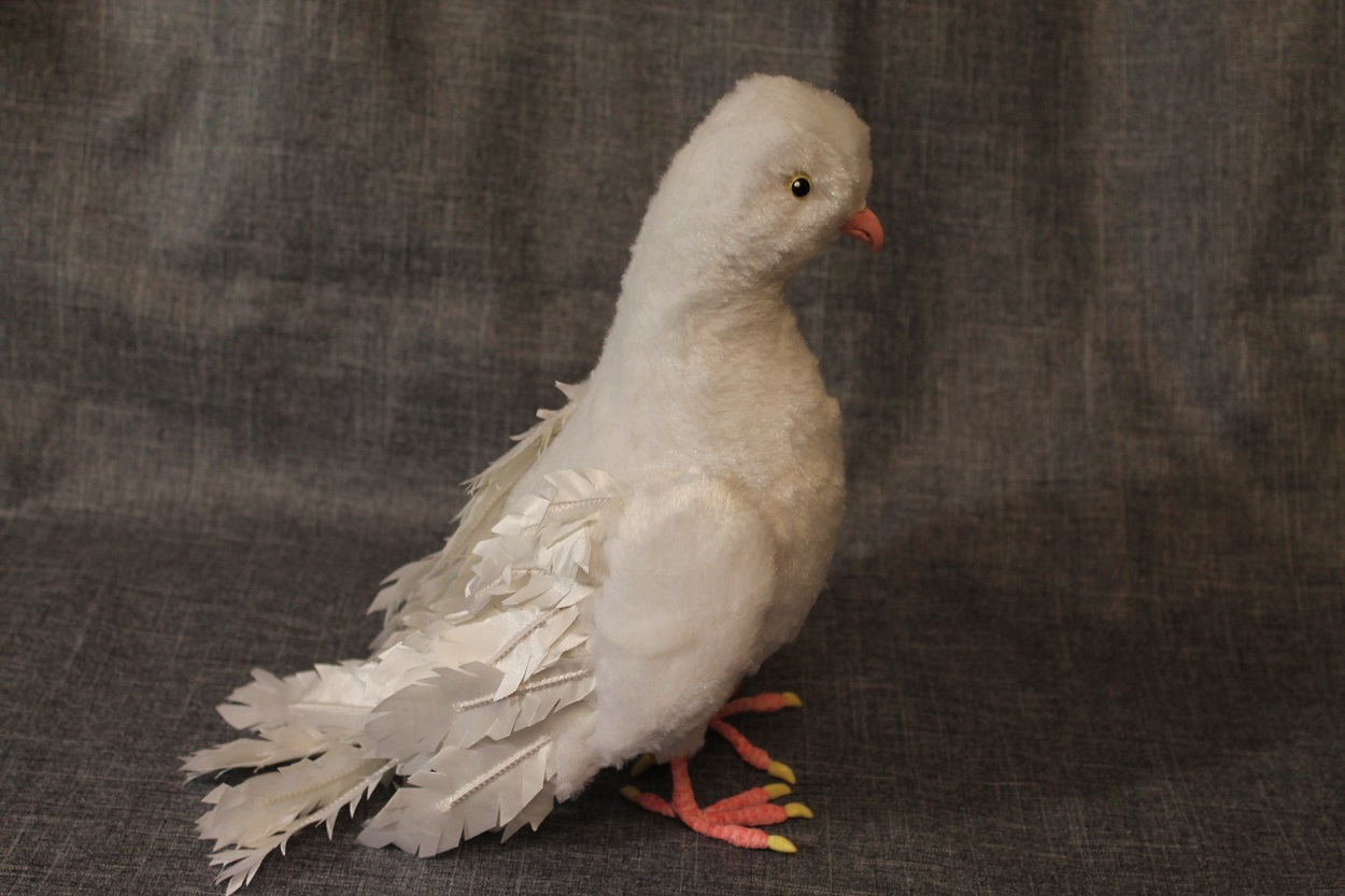 White dove plush with fanned tail White dove plush with a fanned tail of fabric feathers and pink feet, a custom pigeon plush sewn to order