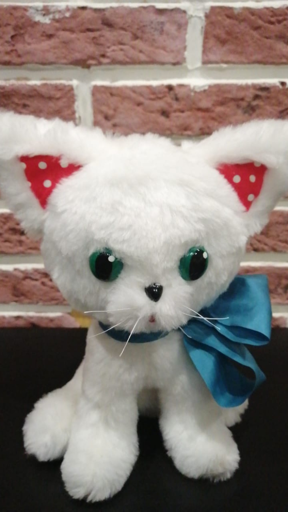 White kitten plush with polka-dot ears and green eyes, handmade to order from a customer's picture