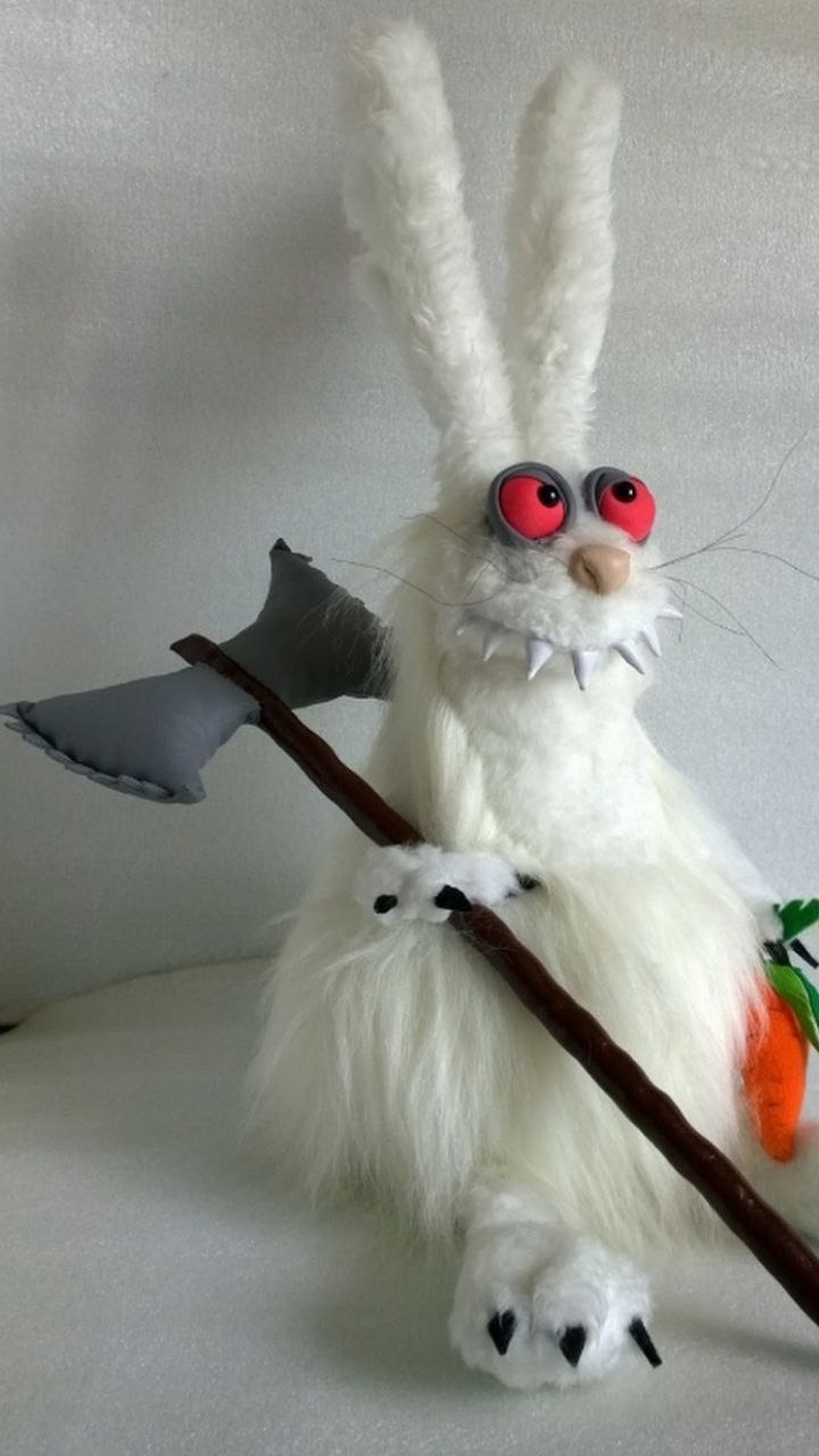 White rabbit plush with red eyes and fangs, made to order from a drawing: black claws, axe and orange carrot