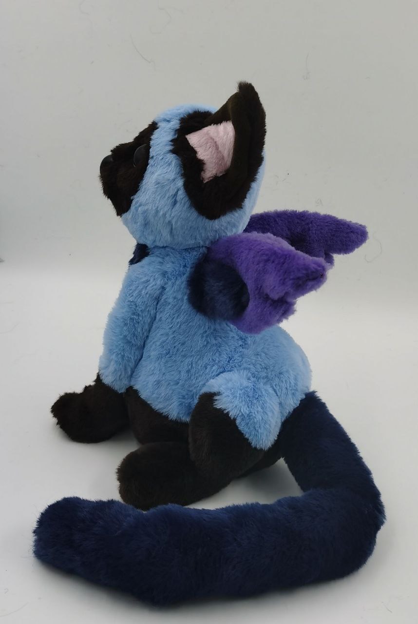 Winged cat plush with a long tail Winged cat plush with a long navy faux fur tail and two-tone purple wings, handmade from a character drawing