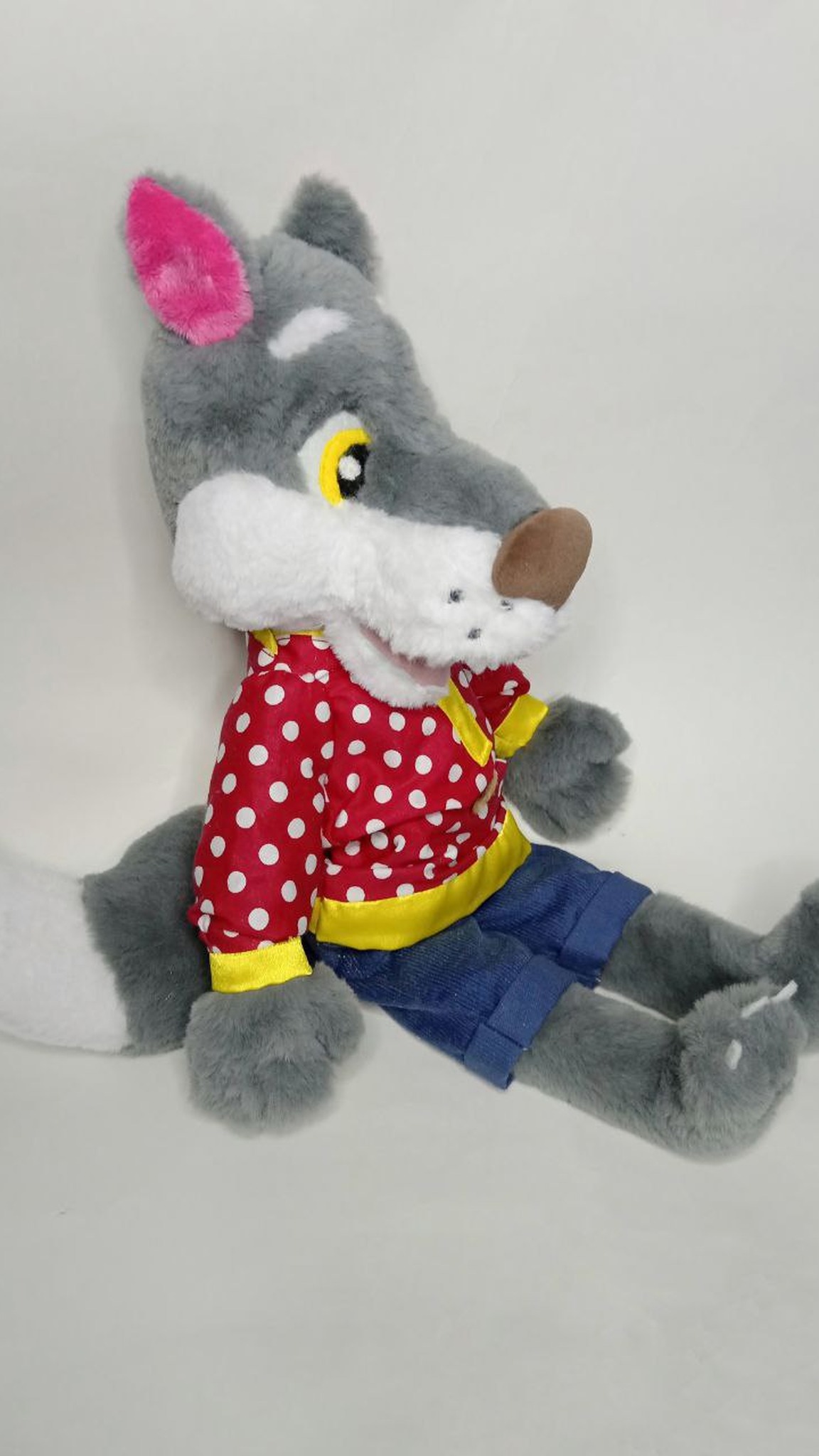 Wolf cub plush made to order, sitting with bendable paws and a white-tipped tail, in a red polka-dot shirt