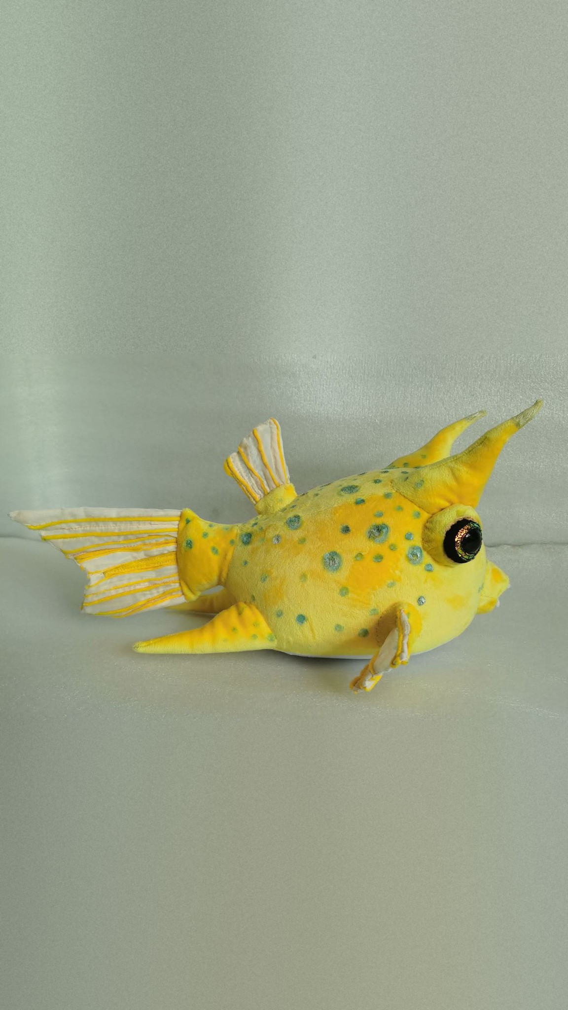 Yellow boxfish plush with teal spots and a gold-green glitter eye, a longhorn cowfish sewn to order