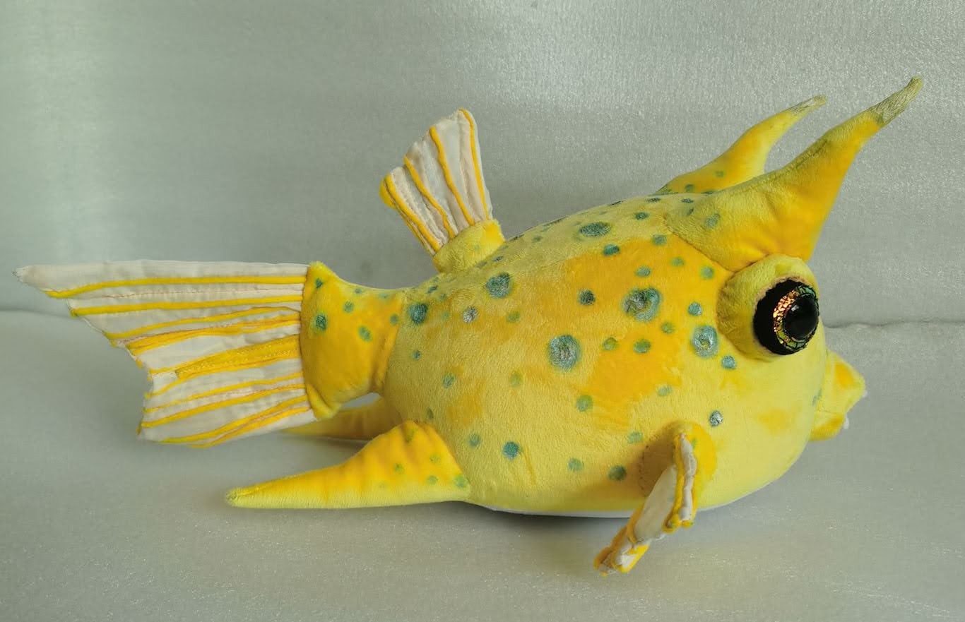 Yellow boxfish plush with teal spots Yellow boxfish plush with teal spots and a gold-green glitter eye, a longhorn cowfish sewn to order