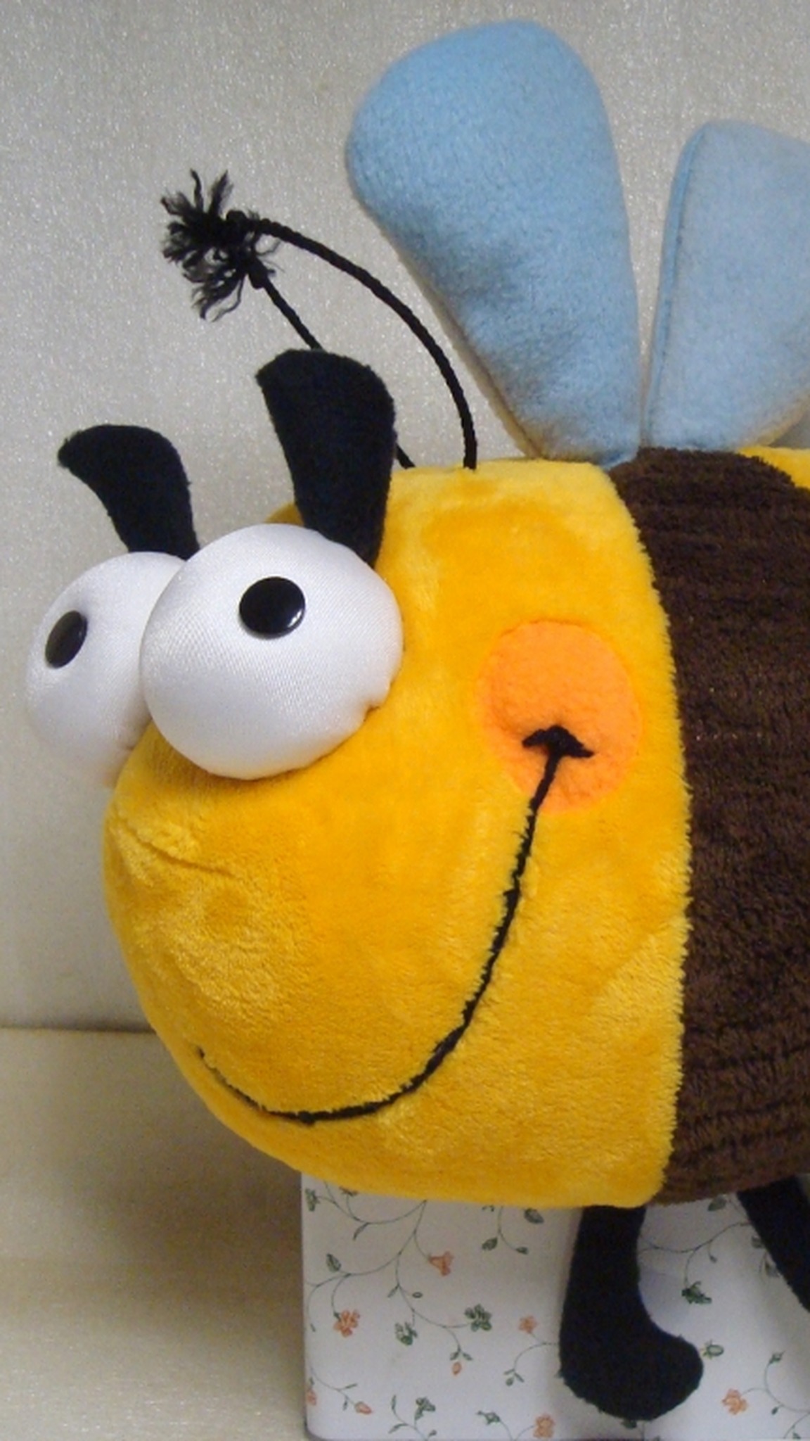 Yellow bumblebee plush on a gift tin, black legs and stinger, googly eyes, handmade to order from a drawing
