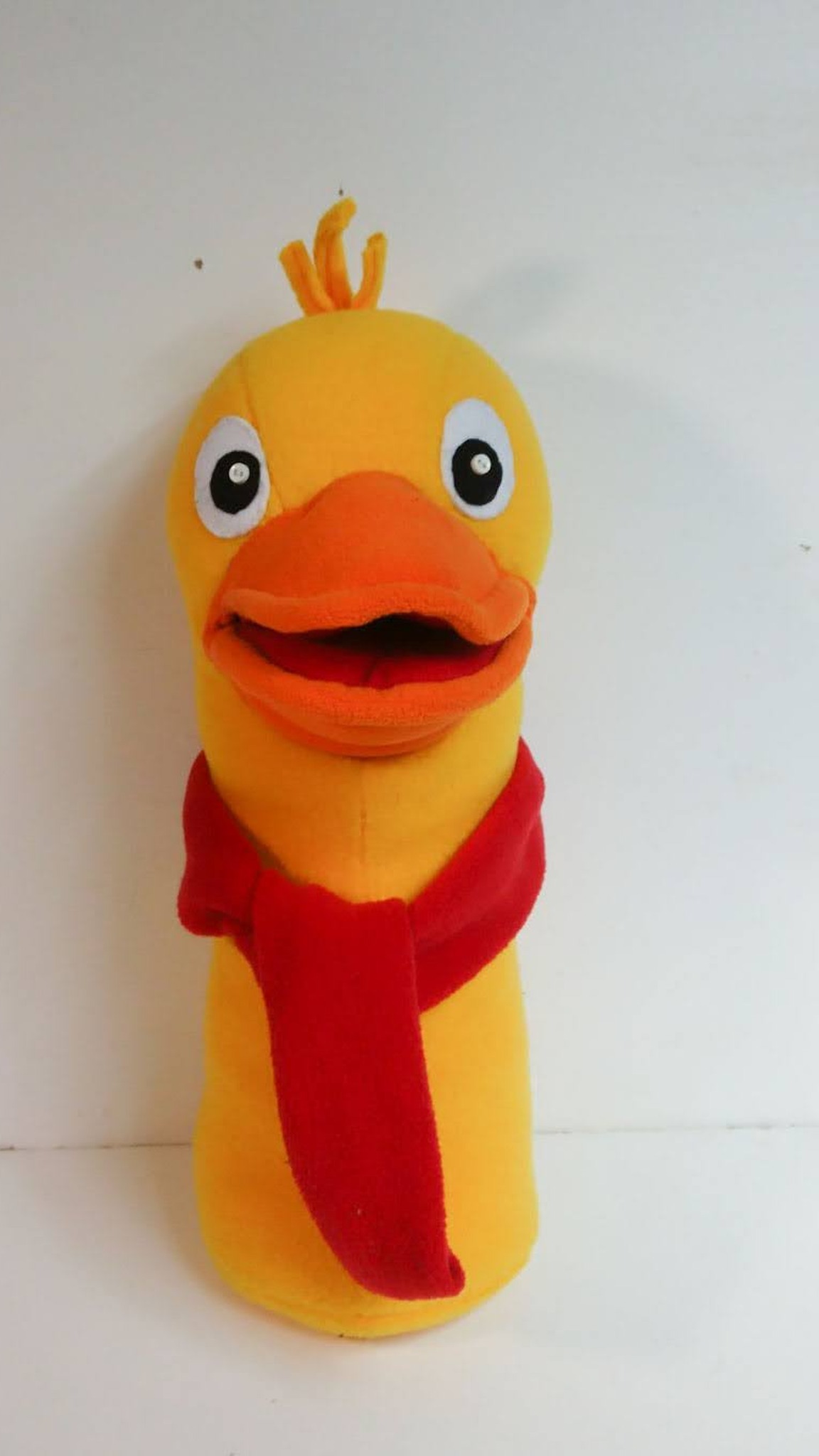 Yellow duck plush with an open orange bill, felt eyes, a yarn tuft and a red fleece scarf, made to order