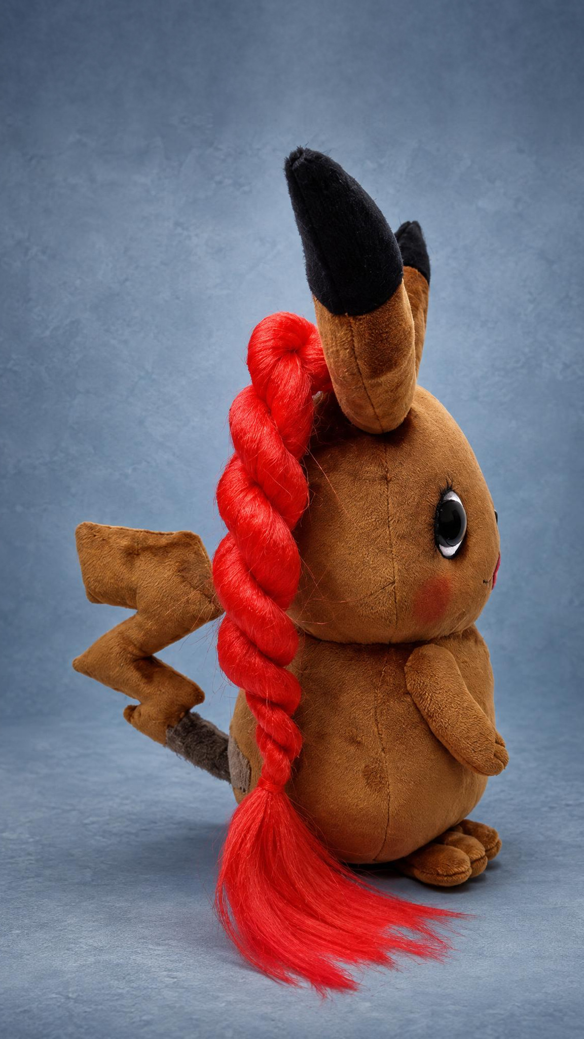 Brown Pikachu plush with a long red braid and lightning tail, a custom look-alike handmade to order
